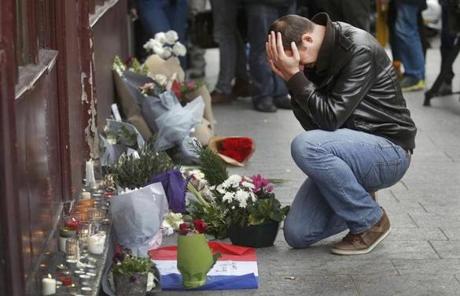 A man paid his respect outside the Le Carillon restaurant the morning after a series of deadly attacks in Paris.
